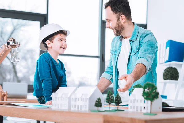 Purposeful dad showing a project to the son