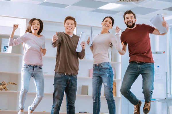 Exuberant four colleagues seeing result — Stock Photo, Image