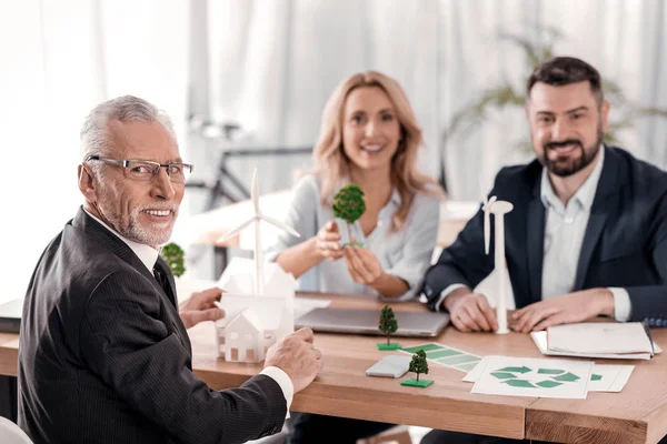 Joyful businesspeople sitting at the table — Stock Photo, Image