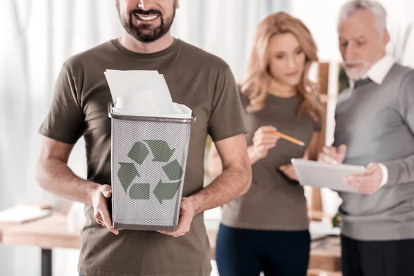 Alert man holding a litter bin — Stock Photo, Image