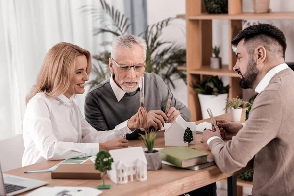 Cheerful female ecologist looking at the beaker — Stock Photo, Image