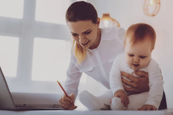 Financial director on maternity leave correcting her business data — Stock Photo, Image