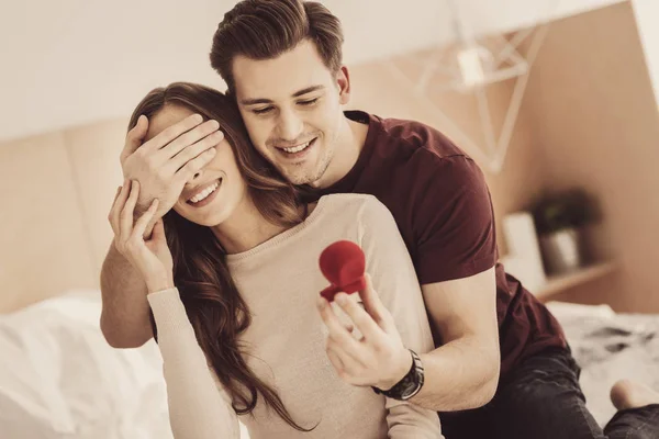 Handsome man closing eyes for his smiling girlfriend — Stock Photo, Image