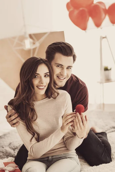 Future husband smiling while hugging his beautiful beaming girlfriend — Stock Photo, Image