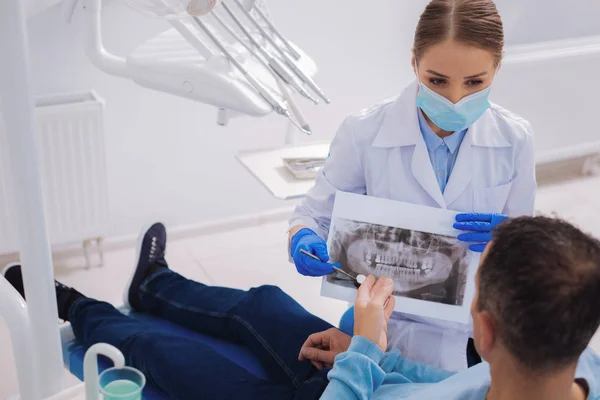 X ışını görüntüyü onun hastaya gösterilen profesyonel diş hekimi — Stok fotoğraf