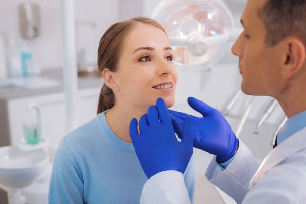 Careful doctor wearing gloves while examining his patient — Stock Photo, Image