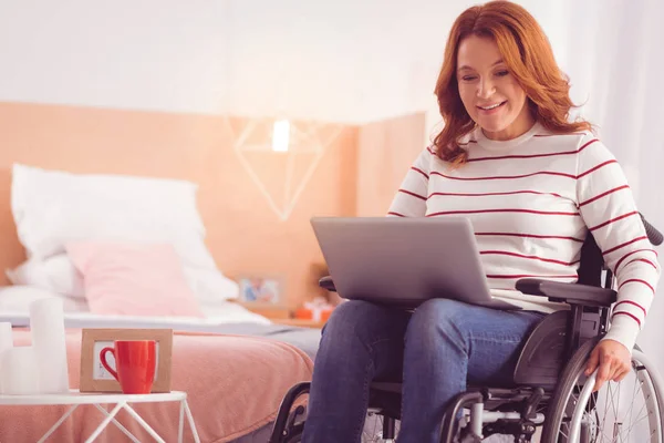 Positive incapacitated woman surfing the net — Stock Photo, Image