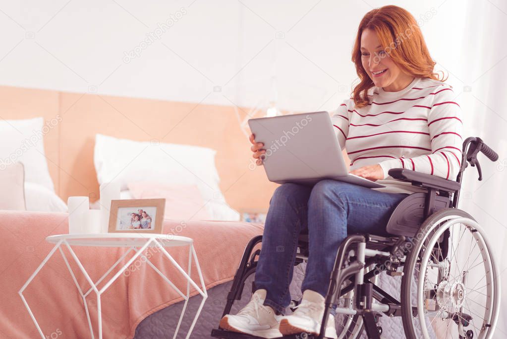 Positive disabled woman surfing the internet