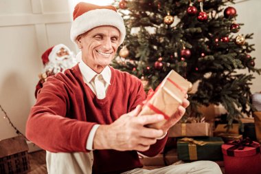 Gülümseyen ve hediye tutarak mutlu baktılar adam.