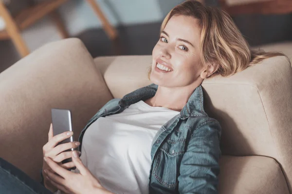 Joyful delighted woman smiling to you