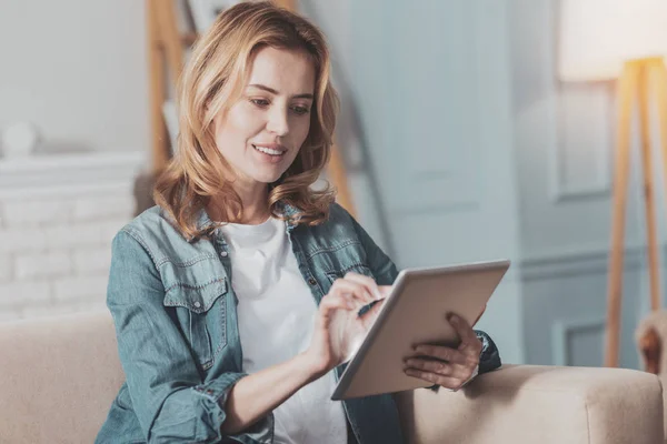 Joyful attractive woman surfing the internet