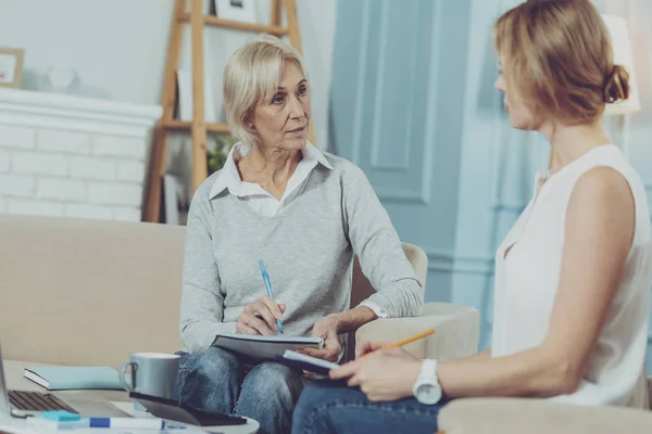 Aged woman having discussion with her financial advisor — Stock Photo, Image