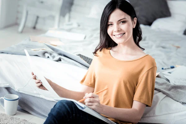 Positive brunette female making notes — Stock Photo, Image