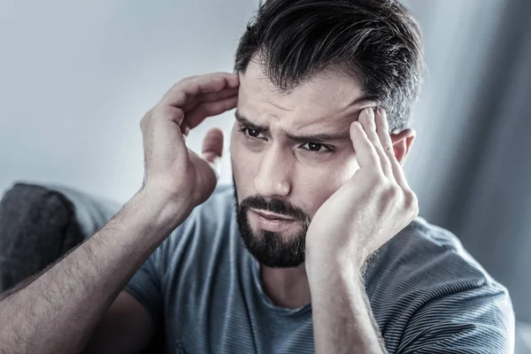 Exhausted bearded male person looking forward — Stock Photo, Image