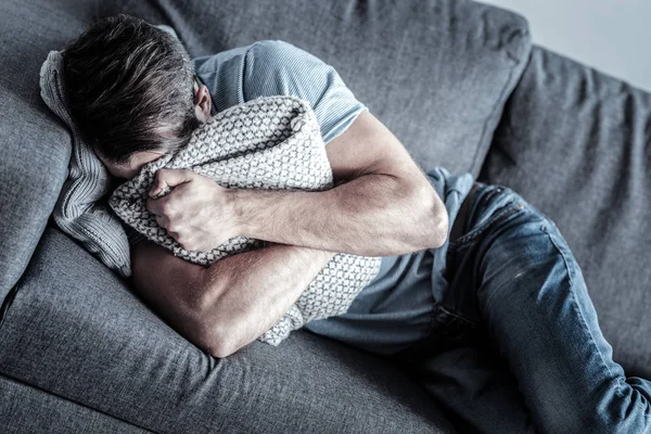 Bother Upset Male Holding Pillow Both Hands Lying Sofa While — Stock Photo, Image