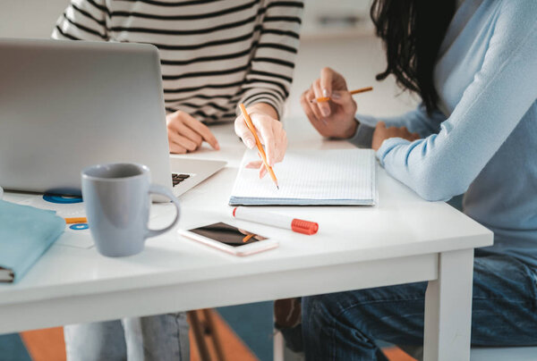 Two smart businesswoman sitting at their working table