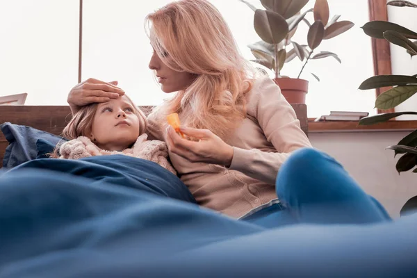 Blonde lady taking care of a child — Stock Photo, Image