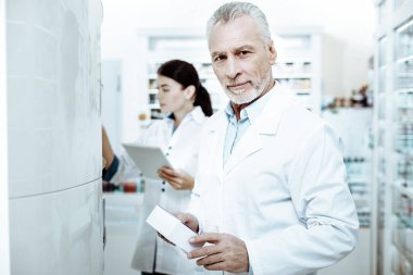 Neşeli pharmaceutist ön ürünler yakınındaki tutuyoruz