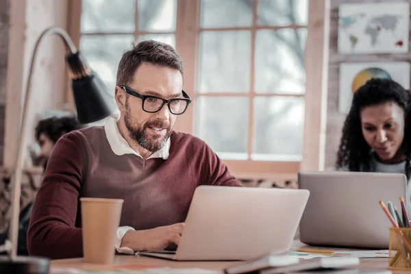 Positive delighted bearded man working at computer — Stock Photo, Image