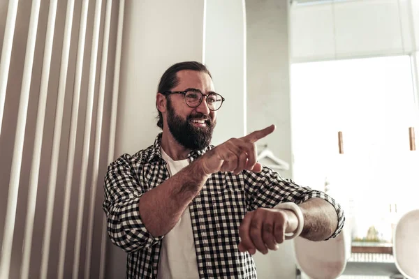 Delighted joyful man pointing with is finger — Stock Photo, Image