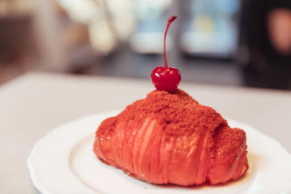 Beautiful crispy croissant with a cherry on top — Stock Photo, Image