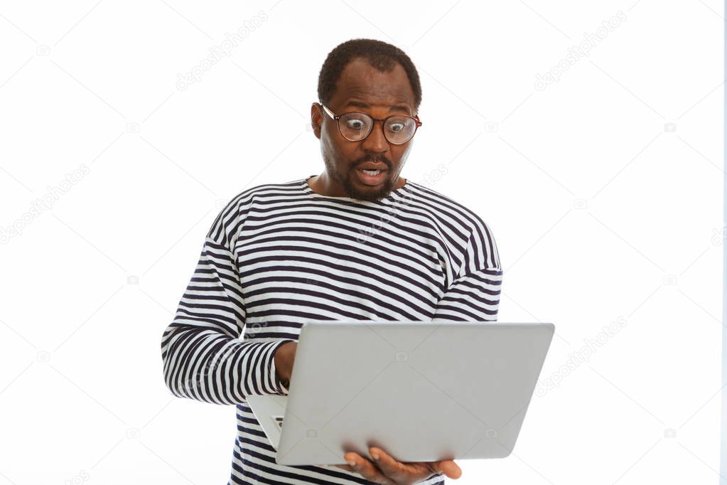 Surprised nice man reading morning news on the Internet