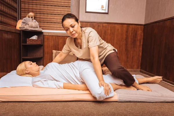 Nice pleasant Thai woman focusing on her work — Stock Photo, Image