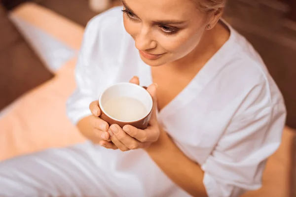 Vista dall'alto di una tazza con tè in mani femminili — Foto Stock