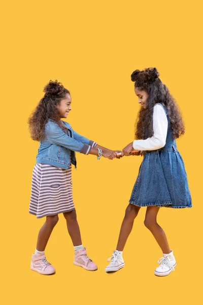 Nice afro American girls fighting for the tablet — Stock Photo, Image