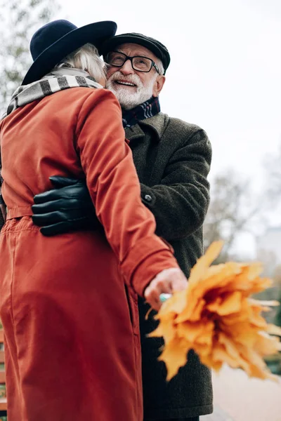 Potěšen zralý muž objímá svou krásnou ženu — Stock fotografie