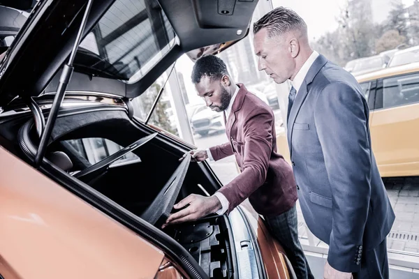 Empresario con traje oscuro disfrutando de sus compras de coches en fin de semana — Foto de Stock