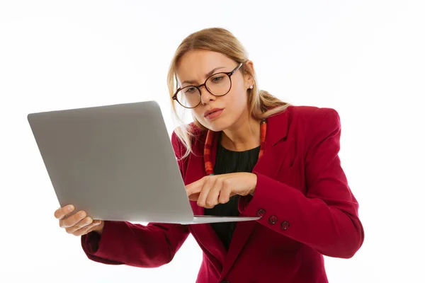 Serious young woman focusing on her work — Stock Photo, Image