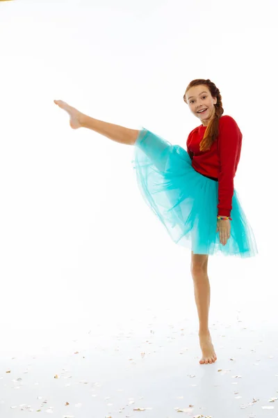 Радостная счастливая девушка держит ногу вверх — стоковое фото