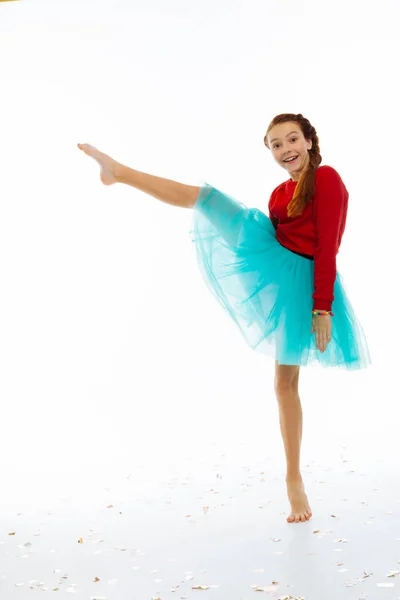 Joyful happy girl holding her leg up — Stock Photo, Image