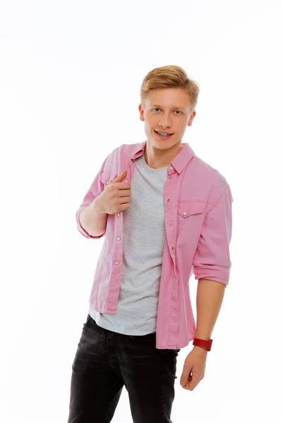 Nice good looking man touching his pink shirt — Stock Photo, Image