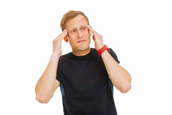 Depressed unhappy young man touching his temples — Stock Photo, Image