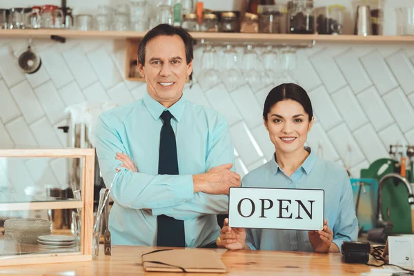 Pleasant man and woman opening their coffee shop — Stock Photo, Image