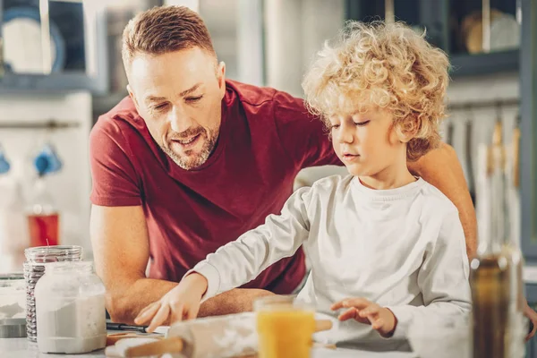 Handsome man and boy challenging in baking