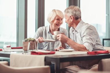 Emekli erkek ve kadın sabah kahvesi yiyorsunuz