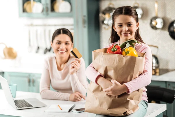 Good girl holding big paper bag with products — стоковое фото