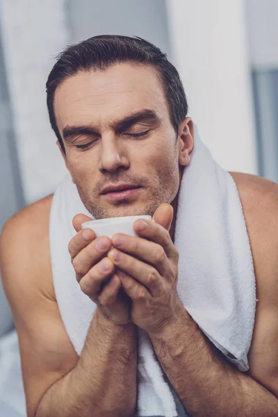 Angenehmer gutaussehender Mann genießt den Kaffeegeruch — Stockfoto