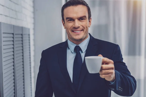Веселий привабливий чоловік пропонує вам каву — стокове фото