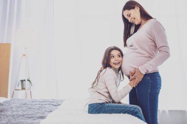 Neşeli kız bebek anne karnında tekme için dinleme