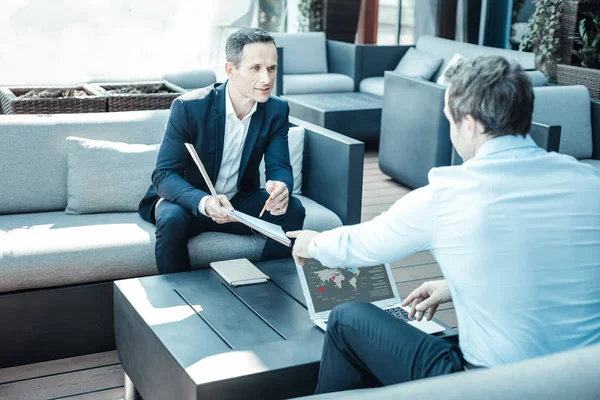 Positive delighted male person showing his notes — Stock Photo, Image