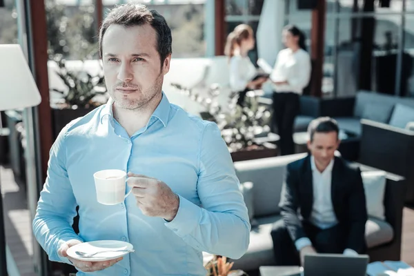 Relaxed man going to drink coffee — Stock Photo, Image