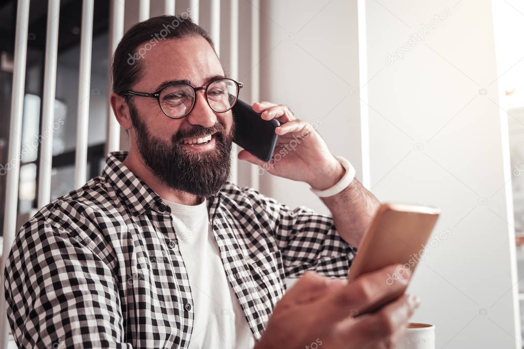 The busy man using two smartphones for working
