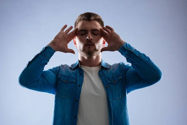 Nice calm young man closing his eyes — Stock Photo, Image