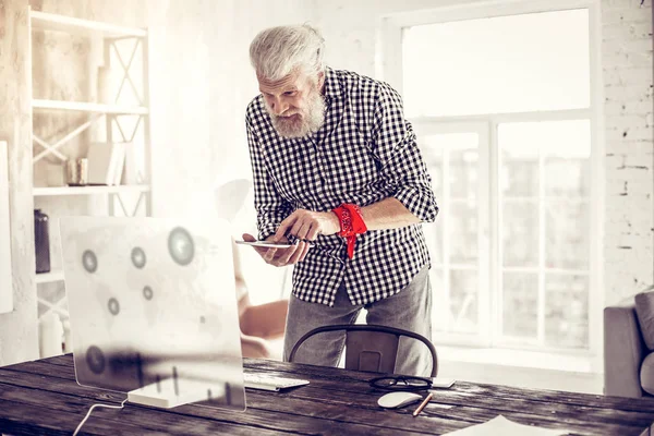 Handsome bearded man standing near his workplace — Stock Photo, Image