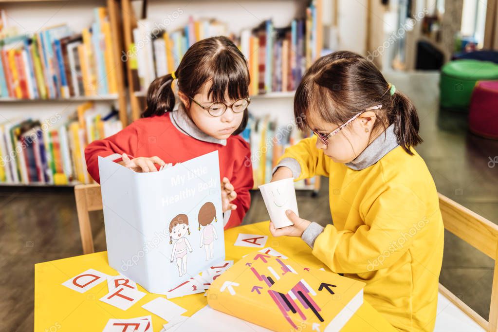 Sisters with Down syndrome studying in inclusive kindergarten
