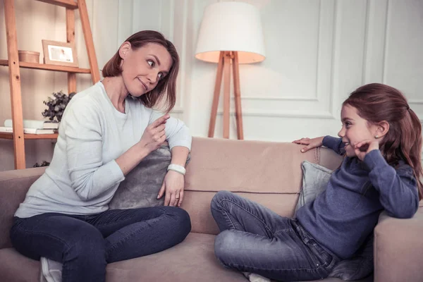 Nice young woman talking to her daughter